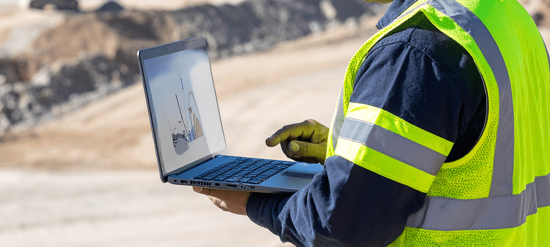 Engineer looking at charts on laptop Engineer looking at charts on laptop